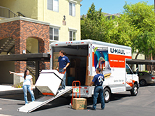 Movers unloading a U-Haul truck