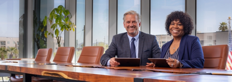 2 Business professionals sitting at a conference table