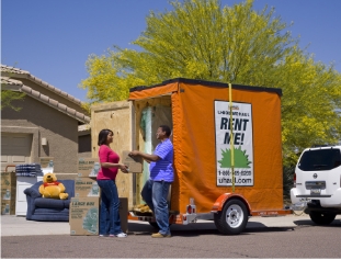 A couple unloading a U-Box storage container