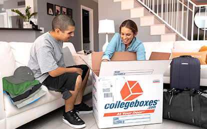 Parent and student packing a moving box