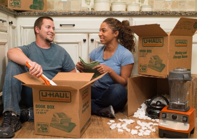 A couple putting goods into a box