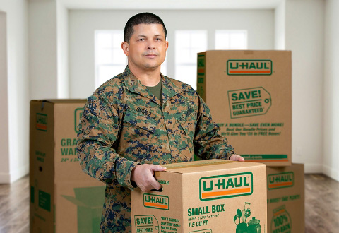 Military service man holding a U-Haul moving box