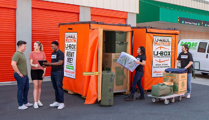 Military family loading their belongings into a U-Box container at a U-Haul Moving and Storage facility