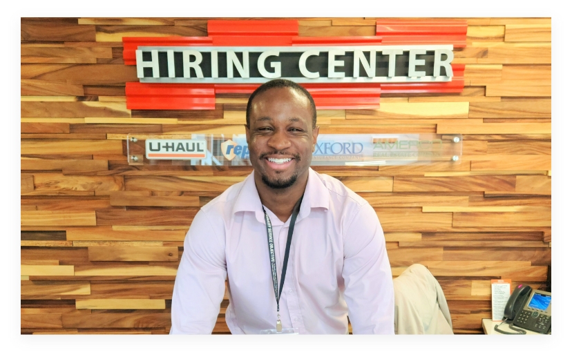 A military employer standing behind a table at a hiring center