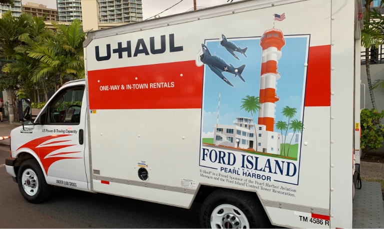 A 10 foot U-Haul truck with a Supergraphics design on its side