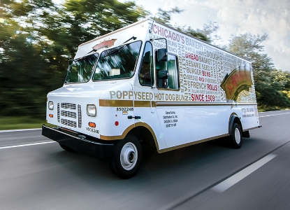 A food truck driving on a road