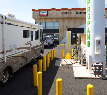 An RV (Recreational Vehicle) is parked at a U-Haul Propane refill station