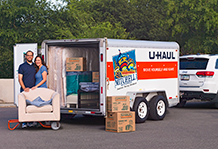 A couple unloading a trailer.