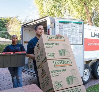 Moving helpers unloading a U-Haul moving truck