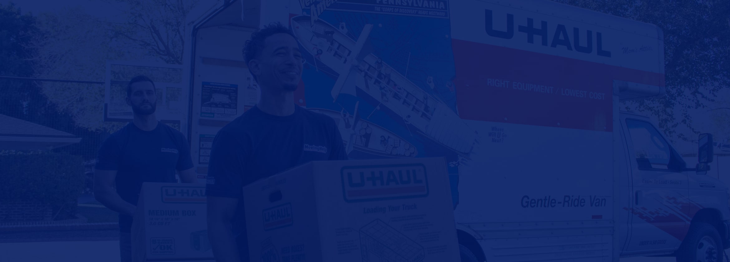 Moving Helpers moving boxes from a U-Haul moving truck