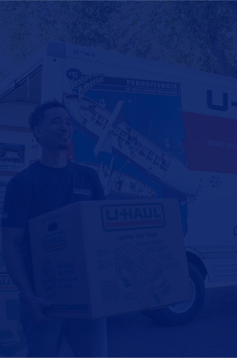 Moving Helpers moving boxes from a U-Haul moving truck