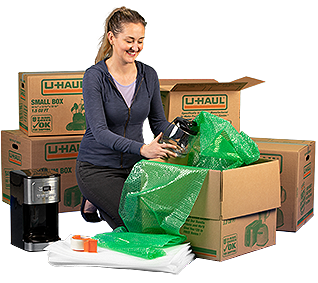 A woman packing moving boxes