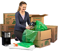 A woman packing moving boxes