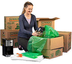 A woman packing moving boxes