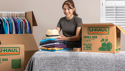 Woman unpacking items from moving boxes