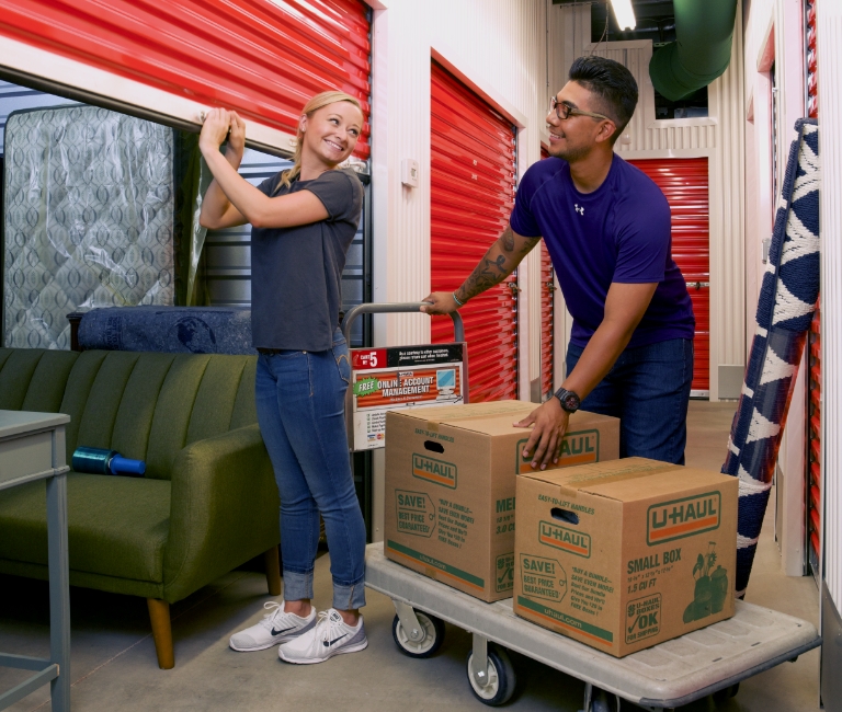 Couple loading items into a self storage container