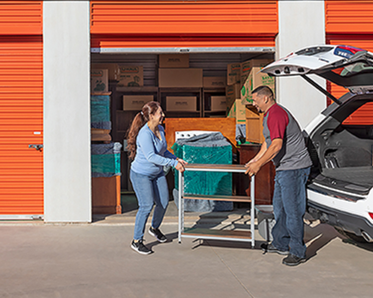 Couple loading items into a self storage container