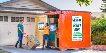 Couple loading a U-Box Container in their driveway